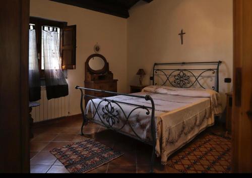 a bedroom with a bed and a cross on the wall at Villa Concetta in San Giovanni in Fiore