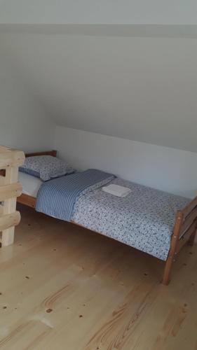 two twin beds in a room with a wooden floor at Apartmani Jovanovic in Perućac