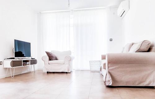 a white living room with a couch and a chair at Villa Regina Serafina in Balchik