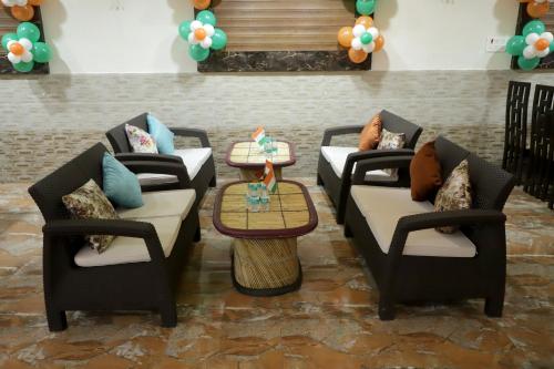 a room with four couches and a table at HOTEL ROYAL ORBIT in Neemrana