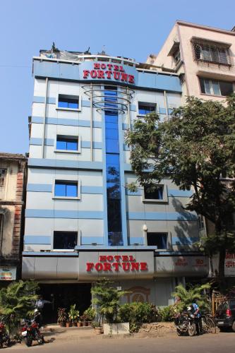 a white building with a dont bite sign on it at Hotel Fortune in Mumbai
