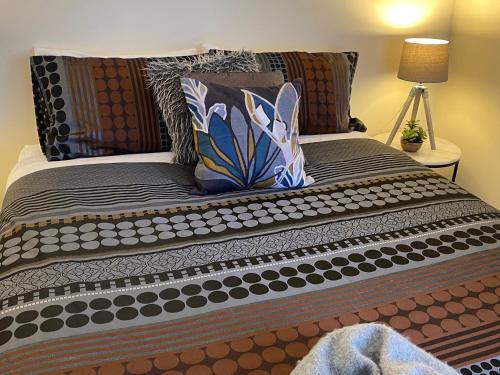 a large bed with some pillows on it at Apartment 244 on Bertha, Mount Gambier in Mount Gambier