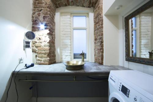 a laundry room with a sink and a window at Lviv4U in Lviv