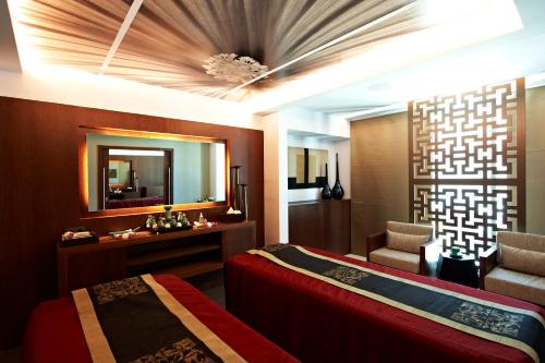 a hotel room with two beds and a mirror at Palácio Estoril Hotel, Golf & Wellness in Estoril