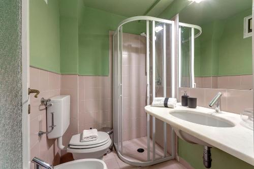 a bathroom with a toilet and a sink and a shower at San Niccolò Apartment by Mamo Florence in Florence