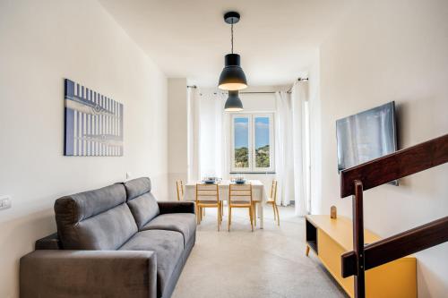 a living room with a couch and a table at Casa Titì by Feeling Italy in Massa Lubrense