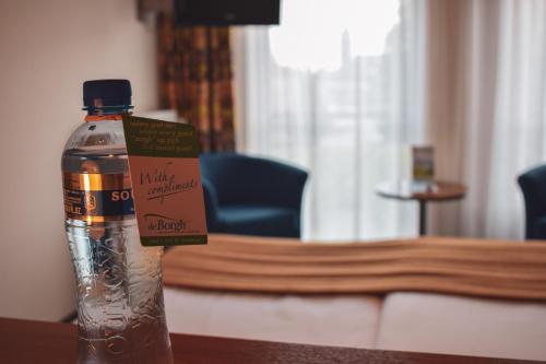 a bottle of water sitting on top of a table at De Borgh in Zevenbergen