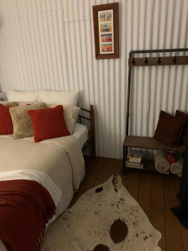 a bedroom with a bed and a rug on the floor at Evanston Station in Ilfracombe