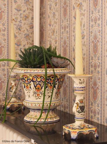 a table with two vases and a candle and a plant at Domaine des Thomins in Cisai-Saint-Aubin