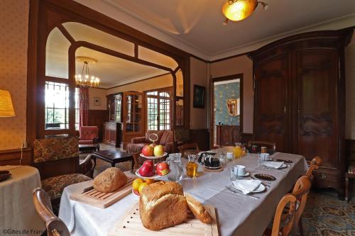 a dining room with a table with bread and fruit on it at Domaine des Thomins in Cisai-Saint-Aubin