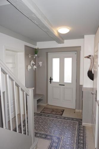 a hallway with a white door and a staircase at Altstadtperle Wernigerode in Wernigerode