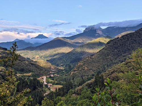 a view of a valley with mountains in the background at Olmares Terrace Apartment - Picos de Europa in Lomeña