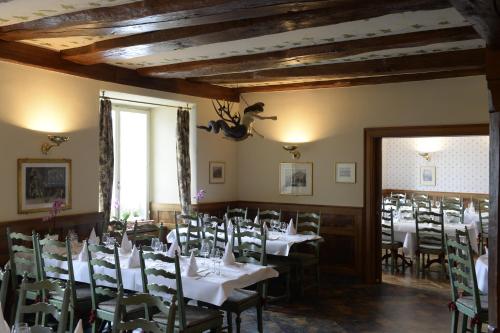 a dining room with white tables and chairs at Hotel Rheinfels in Stein am Rhein