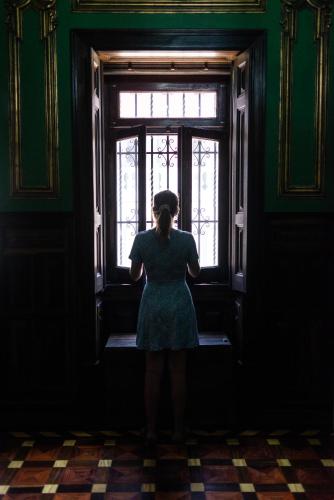 a woman standing in front of a window at Sant Jordi Hostels Lisbon in Lisbon