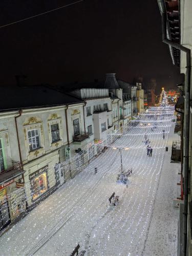 a street with christmas lights in a city at night at Apartament In Inima Dornei in Vatra Dornei