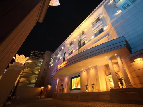 a building at night with lights on it at Hotel Fine Garden Kyoto Minami in Kyoto