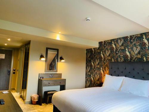 a hotel room with a bed and a fireplace at Wildes Inns in Chesterfield