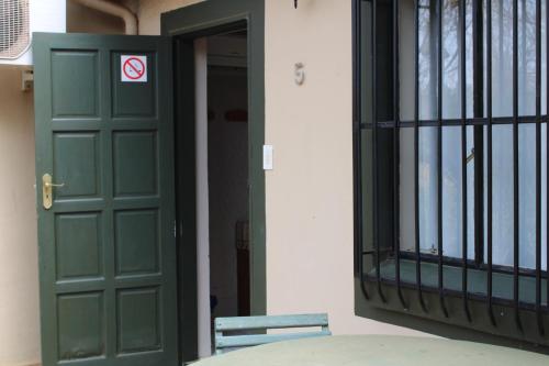 a green door with a no entry sign on it at Honey Lodge in Klipdrift