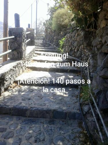 a set of stone steps in front of a stone wall at casarno grande el guro in Calera