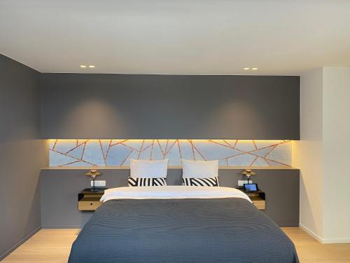 a bedroom with a large bed with two night stands at Smartflats - Fashion in Brussels