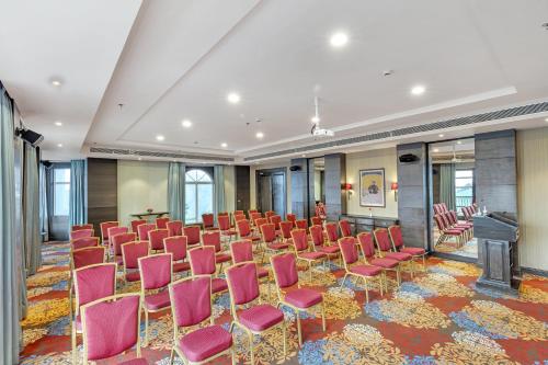 a conference room with chairs and a podium in the middle at Club Mahindra Pristine Peaks Naldehra in Shimla
