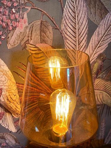 two vases with candles in them on a table at Wildes Inns in Chesterfield