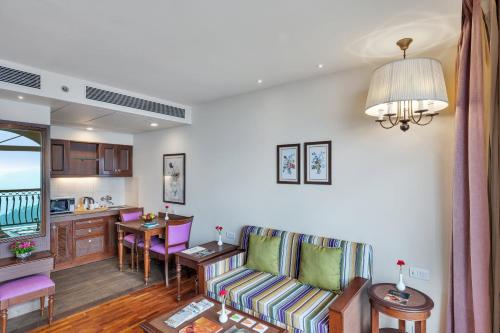 a living room with a couch and a table at Club Mahindra Pristine Peaks Naldehra in Shimla