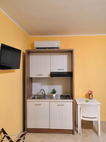 a small kitchen with a stove and a table at Fratelli Clemente Spa and Hotel in Castelvetrano Selinunte
