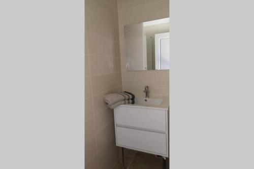a bathroom with a white sink and a mirror at Diamond - Gîte dans vieux prieuré près de Carcassonne in Sainte-Eulalie