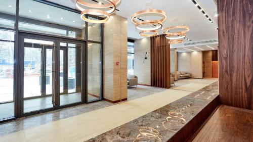 a lobby with large windows and chandeliers at Rent VIP apartment in Kyiv in Kyiv