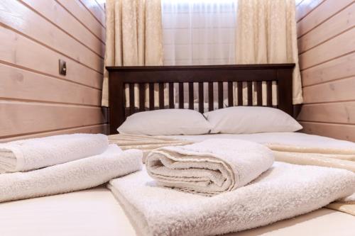 two beds with towels on them in a room at Маєток "ZYMON & SKI" in Bukovel