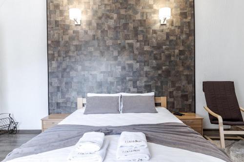 a bedroom with a bed with two towels on it at Маєток "ZYMON & SKI" in Bukovel