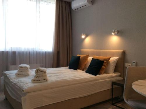 a bedroom with a large bed with towels on it at Smart Studio Galaxy 2 floor in Kyiv