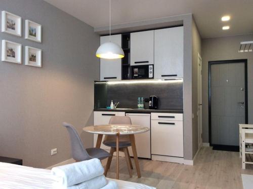 a kitchen with a table and a small table and chairs at Smart Studio Galaxy 2 floor in Kyiv