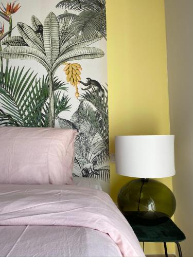 a bedroom with a bed with a lamp next to it at Allegro Holiday in Nizza Monferrato