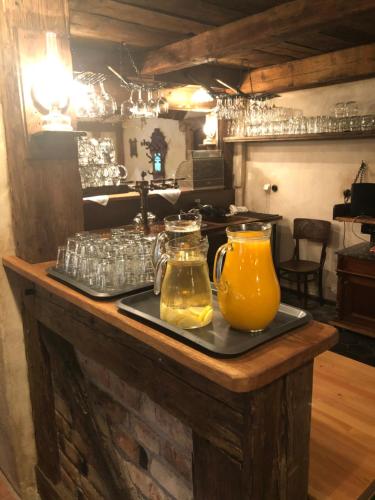 a table with two pitchers of orange juice and glasses at Kazmarka in Malá Morávka