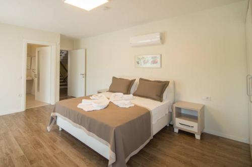 a bedroom with a bed with towels on it at CRESCENT TWINS- BLUE VİLLA in Dalyan
