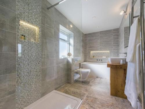 a bathroom with a tub and a toilet and a sink at chyreen@marazion in Marazion