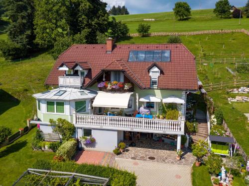 an aerial view of a white house with a porch at Privatzimmer Haus Gschweitl in Semriach