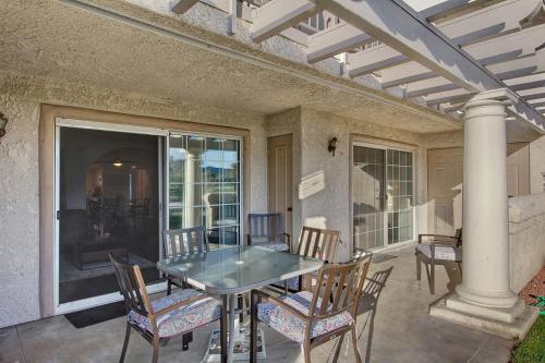 a patio with a table and chairs on a porch at Our Mesquite-Refreshed 1st floor nature preserve & mtn view condo! in Palm Springs