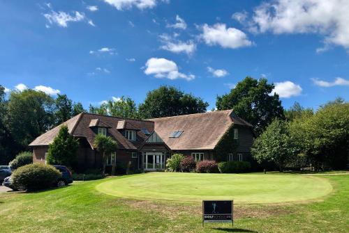 a house on a golf course with a green at Sedlescombe Golf Hotel in Sedlescombe