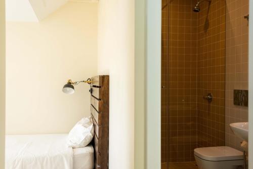 a bathroom with a toilet a sink and a shower at Sant Jordi Hostels Lisbon in Lisbon
