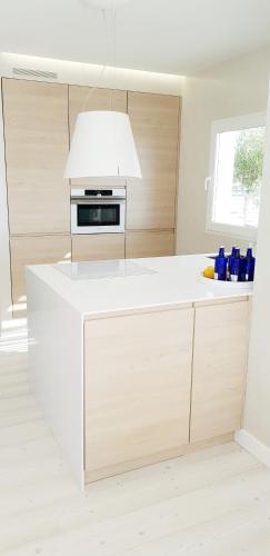 a kitchen with a white counter top and a white ceiling at Suit Mar y Sol in Cala Ratjada
