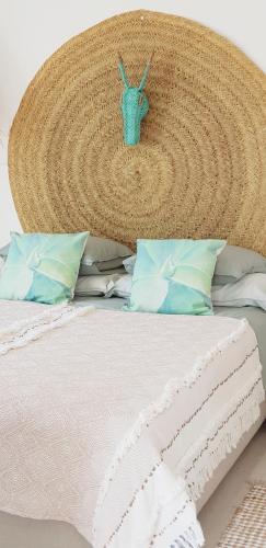 a bed with a large hat on top of it at Suit Mar y Sol in Cala Ratjada