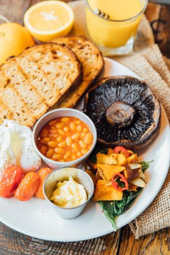 a plate of breakfast food with eggs beans and toast at Kings Arms Hotel in Berkhamsted