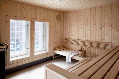a sauna with two windows and a bench in a room at Villa Copenhagen in Copenhagen