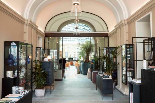 a store hallway with a large window and plants at Villa Copenhagen in Copenhagen