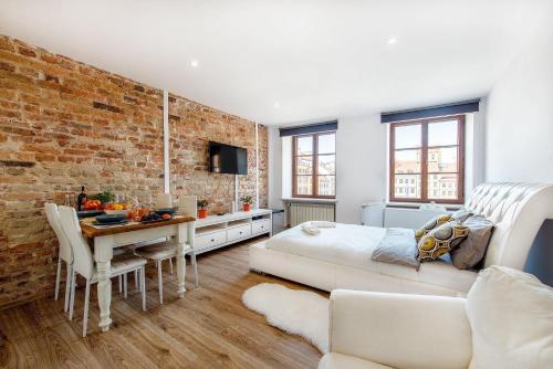 a living room with a brick wall at Old Town Home in Warsaw