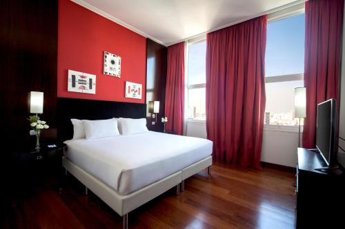 Ένα ή περισσότερα κρεβάτια σε δωμάτιο στο NH City Buenos Aires