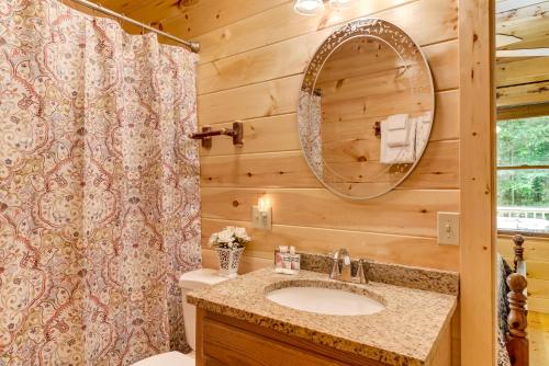 a bathroom with a sink and a mirror at Moonshine Run in Blue Ridge